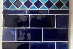 Square and triangle border with brick field tiles: deep blue and Turkish blue